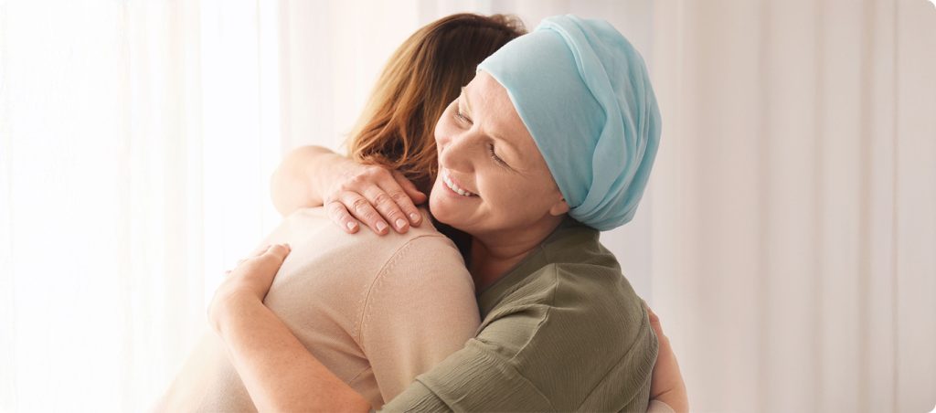 compassionate-cancer-care A photo of a patient hugging their doctor